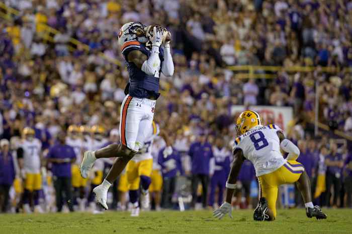 Oct 14, 2023; Baton Rouge, Louisiana, USA; Auburn Tigers cornerback D.J. James (4) makes a interception against LSU Tigers wide receiver Malik Nabers (8) during the second quarter at Tiger Stadium. Mandatory Credit: Matthew Hinton-USA TODAY Sports  